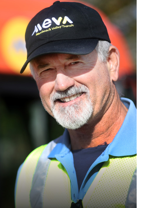 Smiling bus driver wearing Meva transit hat