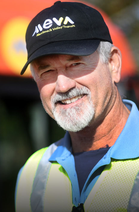 Smiling bus driver wearing Meva transit hat